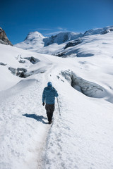 Trekker walking on snow with Mera Peak in background, Nepal