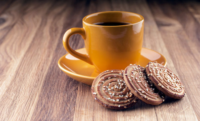 Colorful cup of coffee and cookies on wooden background.