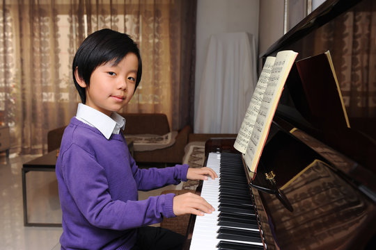 Young Asian boy playing piano