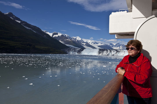 Tourist on cruise ship admires scenery in College Fjord
