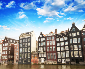 Fototapeta premium Amsterdam. Beautiful view of classic buildings with colourful sk