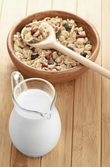 Plate with raw oatmeal on wooden table.