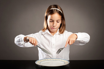 little hungry girl sitting at table © xavier gallego morel