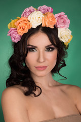 Naklejka premium Beautiful young woman with flower wreath. Fashion shot. Portrait