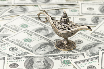 aladdin lamp on dollar background