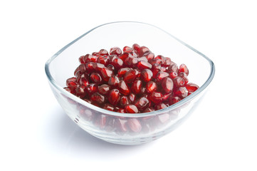 pomegranate seeds in glass bowl isolated on white