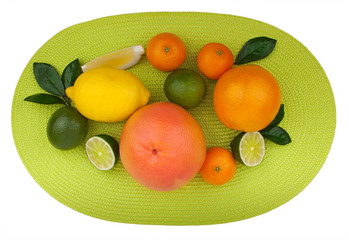 Citrus fruits on green table napkin isolated on white background