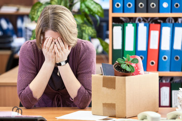 Dismissed woman crying, last time sitting at your desk