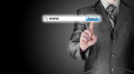 Businessman pushing virtual search bar