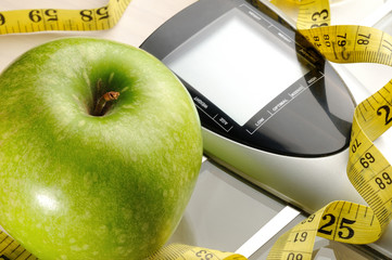 healthy apple, measuring tape and scale