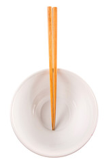 A pair of wooden chopstick and a bowl