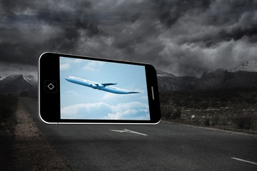 Composite image of airplane on smartphone screen