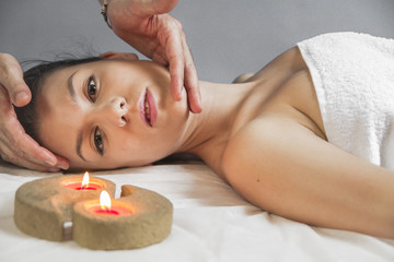 Massaging, portrait of young beautiful woman in spa environment