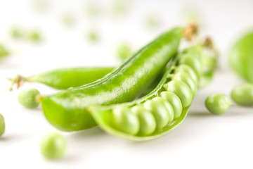 fresh green peas on white