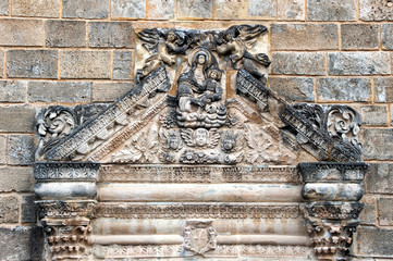 detail of stone sculpture at the wall of a church