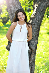 Fototapeta premium Portrait of beautiful smiling girl in a summer park