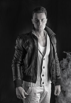Handsome young man with white sweater and black leather jacket.