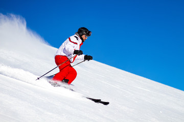 Fototapeta na wymiar Male Skier Speeding Down Ski Slope