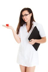 A female doctor holding a heart, isolated on white background