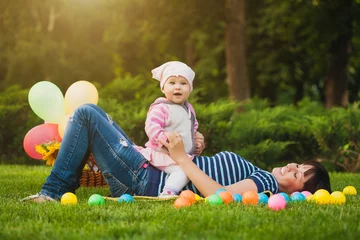 Zelfklevend Fotobehang Happy mom and baby in the green park © Dmytro Titov