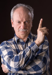 Angry elderly man pointing up