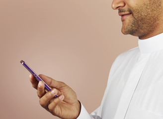 Arabian man watching social media in the smart phone