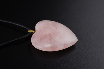Rose quartz heart with leather string on black