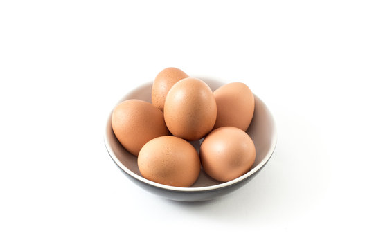 Brown Egg in dish on white background
