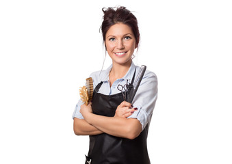 Attractive hairdresser woman with professional tools in her hand