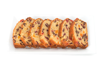 slices of traditional dried fruits cake for christmas on white b