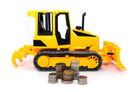 Yellow  tractor and coins isolated over white background