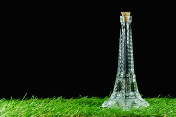 Eiffel tower make of glass bottles on black background