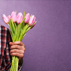man clothing hipster holding a bouquet of flowers