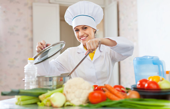 cook in uniform works with vegetables