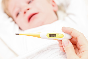 Fever, measuring temperature for little boy