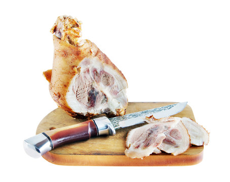Pork ham sliced to pieces on a cutting board