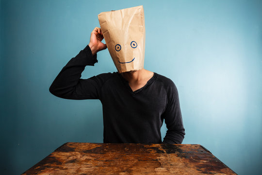 Confused man with bag over his head