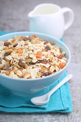 muesli cereal with dried berries, nuts, honey and milk