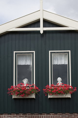 Fototapeta na wymiar Windows of a house with flower boxes.