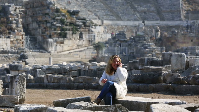 tourist talking phone in ruins ancient Ephesus,steadicam shoot