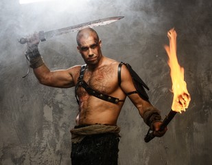 Wounded gladiator with cold weapon and torch