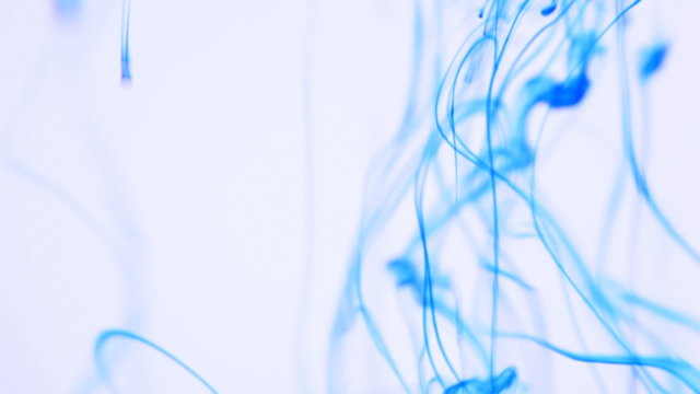 Ink blots are falling and spreading in water.