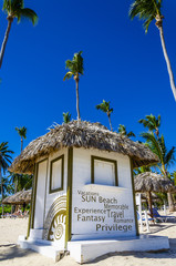 Holidays cottage with a thatched roof on  Dominicana beach - obrazy, fototapety, plakaty