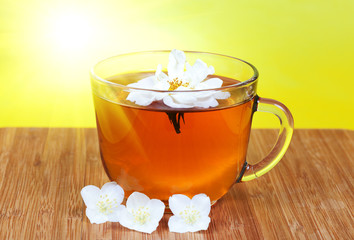 Transparent cup with tea with a jasmine