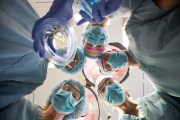 Surgeons With Oxygen Mask In Operation Room