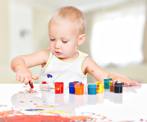 Little baby paint by his hands.