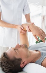 Fototapeta na wymiar Physiotherapist giving hand massage to man