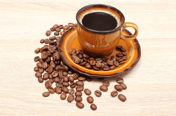 Coffee grains and cup of beverage