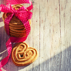 Heart shaped sugar cookie tied with red ribbon