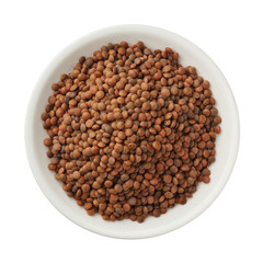 Uncooked lentils in a bowl isolated on white background